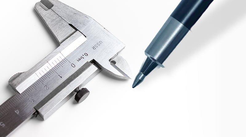 A vernier caliper checking a pen tip